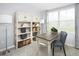 Home office with built-in shelving and large window at 4511 Black Drum Dr, Raleigh, NC 27616