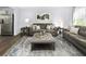 Spacious living room features two sofas, a coffee table, and a view into the kitchen at 4511 Black Drum Dr, Raleigh, NC 27616