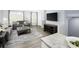 Open concept living area with hardwood floors, a large TV, and comfortable seating at 4511 Black Drum Dr, Raleigh, NC 27616
