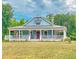 House exterior showcasing a welcoming front porch and American flag at 468 Loftis Loop Rd, Roxboro, NC 27574