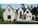 Modern two-story home with gray and white brick exterior, a three car garage, and landscaped front yard at 708 Catawba St, Raleigh, NC 27609