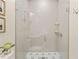 Modern bathroom with walk-in shower, tiled walls, and decorative floor tile at 1641 Legacy Ridge Ln, Wake Forest, NC 27587