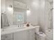 Elegant bathroom with white countertop, tiled shower, and modern fixtures at 1641 Legacy Ridge Ln, Wake Forest, NC 27587