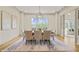 Elegant dining room with large windows, stylish chandelier, and access to another room at 1641 Legacy Ridge Ln, Wake Forest, NC 27587