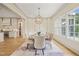 Dining room with hardwood floors, large windows, and a view of the kitchen at 1641 Legacy Ridge Ln, Wake Forest, NC 27587