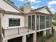 Exterior view of a house with screened porch, stone chimney, and copper gutters at 1641 Legacy Ridge Ln, Wake Forest, NC 27587