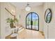 Foyer with wood floors and arched black double-entry doors at 1641 Legacy Ridge Ln, Wake Forest, NC 27587