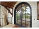Arched black double doors with glass panes and wood overhang at 1641 Legacy Ridge Ln, Wake Forest, NC 27587