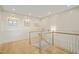 Well-lit hallway with hardwood floors and classic wainscoting at 1641 Legacy Ridge Ln, Wake Forest, NC 27587