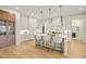 Bright kitchen with island seating, white cabinets, and light hardwood floors at 1641 Legacy Ridge Ln, Wake Forest, NC 27587