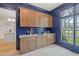 Laundry room with wood cabinetry, granite countertop, and access to a large closet at 1641 Legacy Ridge Ln, Wake Forest, NC 27587