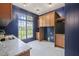 Laundry room with navy blue walls, ample cabinetry, and countertop space at 1641 Legacy Ridge Ln, Wake Forest, NC 27587