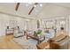 Living room featuring wood floors, exposed beams, and open access to the kitchen at 1641 Legacy Ridge Ln, Wake Forest, NC 27587