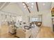 Open-concept living room with view of the kitchen and large windows at 1641 Legacy Ridge Ln, Wake Forest, NC 27587