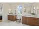 Main bathroom featuring dual vanities, marble flooring, and large window at 1641 Legacy Ridge Ln, Wake Forest, NC 27587