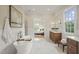 Elegant main bathroom with soaking tub, dual vanities, and marble tile at 1641 Legacy Ridge Ln, Wake Forest, NC 27587