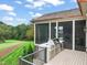 Outdoor kitchen with grill and a view from the deck of the yard and screened porch at 1641 Legacy Ridge Ln, Wake Forest, NC 27587