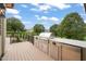 Outdoor kitchen with grill, refrigerator, and ample counter space on a wooden deck at 1641 Legacy Ridge Ln, Wake Forest, NC 27587