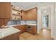 Second kitchen or pantry with wood cabinetry, sink, and hallway access at 1641 Legacy Ridge Ln, Wake Forest, NC 27587