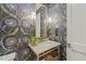 Elegant powder room featuring designer wallpaper and a stylish vanity at 1641 Legacy Ridge Ln, Wake Forest, NC 27587