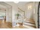 Staircase in the foyer with wood flooring, wainscoting, and entryway access at 1641 Legacy Ridge Ln, Wake Forest, NC 27587