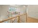 Staircase landing with hardwood floors, wainscoting, a sitting area, and natural light at 1641 Legacy Ridge Ln, Wake Forest, NC 27587