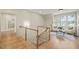 Bright upstairs hallway with a cozy sitting area and hardwood floors at 1641 Legacy Ridge Ln, Wake Forest, NC 27587