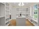 Spacious walk-in closet with custom built-in shelving, center island, and window at 1641 Legacy Ridge Ln, Wake Forest, NC 27587