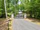 Gated entry to a private estate in a lush forest setting at 1107 Westridge Rd, Rougemont, NC 27572