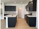 Modern kitchen with dark cabinetry, quartz countertops, and tile backsplash at 3125 Ranger Dr # 42, Durham, NC 27703