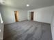 Large bedroom with neutral carpet and multiple closets at 3125 Ranger Dr # 42, Durham, NC 27703