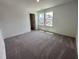 Bright bedroom with carpet and large windows at 3125 Ranger Dr # 42, Durham, NC 27703
