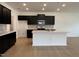 Modern kitchen with dark cabinetry, quartz countertops, and breakfast bar at 3125 Ranger Dr # 42, Durham, NC 27703