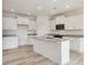 Elegant kitchen boasting white cabinets, granite countertops and island at 46 Nailsworth St, Angier, NC 27501