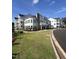 Modern apartment building with attractive landscaping and ample parking at 11548 Helmond Way # 109, Raleigh, NC 27617