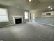 Open living room with high ceilings, fireplace, and kitchen view at 86 Scotties Ridge Dr, Princeton, NC 27569