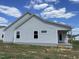 Gray house exterior with a covered back porch and open grassy area at 86 Scotties Ridge Dr, Princeton, NC 27569