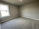 Well-lit bedroom with carpeted floors and neutral walls at 86 Scotties Ridge Dr, Princeton, NC 27569
