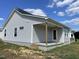 Gray house exterior showcasing a covered porch and side yard at 86 Scotties Ridge Dr, Princeton, NC 27569