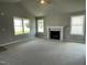 Living room with a cozy fireplace and plenty of natural light at 86 Scotties Ridge Dr, Princeton, NC 27569