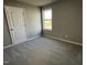Bright bedroom with carpeted floors and a large window at 86 Scotties Ridge Dr, Princeton, NC 27569