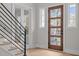 Bright and airy entryway with wood floors and modern staircase at 2833 Theresa Eileen Way, Raleigh, NC 27603