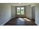 Bright bedroom with two windows, wood-look flooring, and neutral walls at 114 Scotties Ridge Dr, Princeton, NC 27569