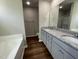 Double vanity bathroom with granite countertop and soaking tub at 114 Scotties Ridge Dr, Princeton, NC 27569