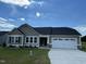 One-story home with taupe siding, white garage door, and stone accents at 114 Scotties Ridge Dr, Princeton, NC 27569