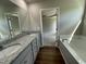 Bathroom with double vanity, granite countertop, and view of bedroom at 114 Scotties Ridge Dr, Princeton, NC 27569