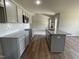 Open kitchen features granite countertops and island overlooking living room at 114 Scotties Ridge Dr, Princeton, NC 27569