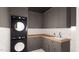 Modern laundry room with gray cabinets and a built-in sink at 3709 Joyful Creek Trl, Zebulon, NC 27597