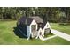 Stunning two-story home with a dark-colored roof and white exterior situated on a lush green lawn at 3709 Joyful Creek Trl, Zebulon, NC 27597