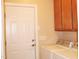 Convenient laundry room with washer, dryer, and built-in cabinets at 3331 Lazy Ln, Graham, NC 27253